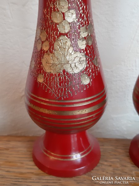 Pair of golden floral metal threaded candlesticks on a red background from the legacy of László Ink