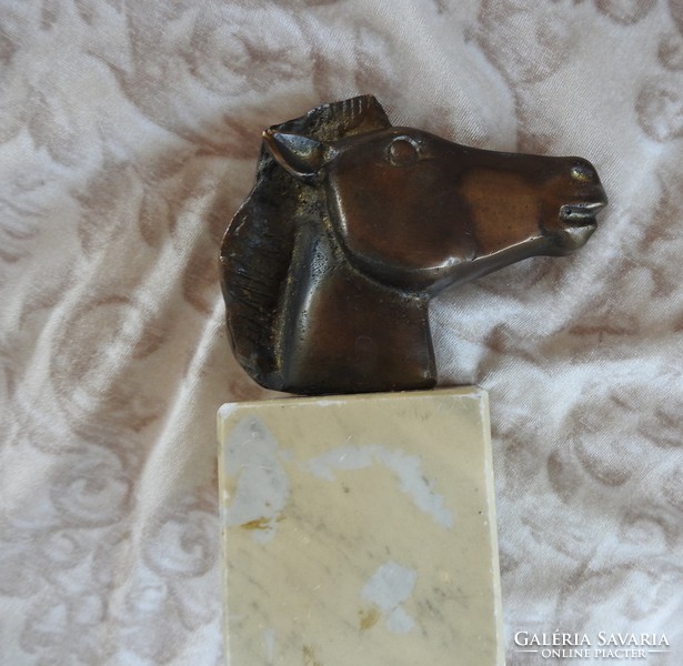 Horse head bronze statue on a marble pedestal