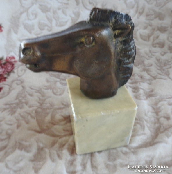 Horse head bronze statue on a marble pedestal