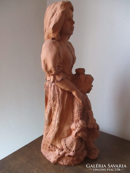 Very beautiful ceramic figurine of mother with her child with a copper sign
