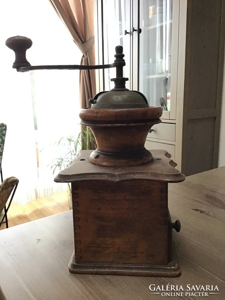 Antique wooden coffee grinder with porcelain interior