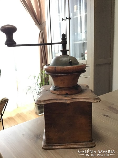 Antique wooden coffee grinder with porcelain interior