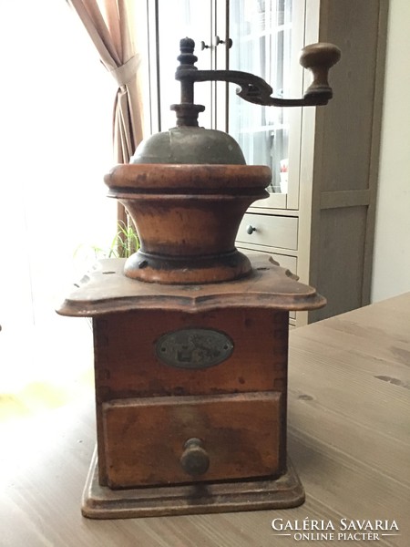 Antique wooden coffee grinder with porcelain interior