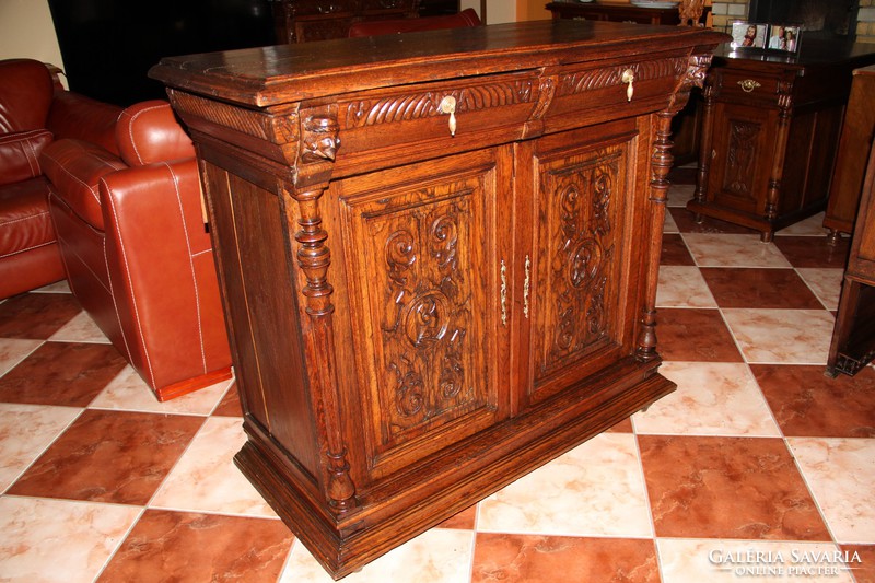 Old German richly carved oak chest of drawers