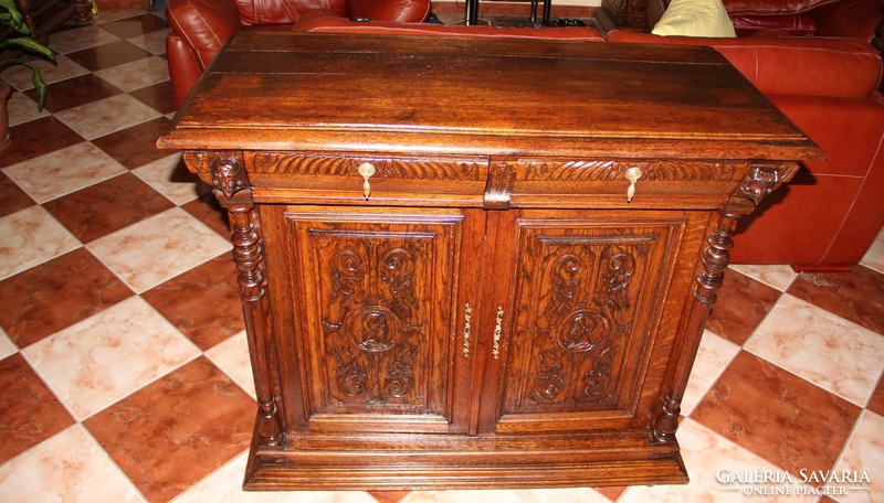 Old German richly carved oak chest of drawers