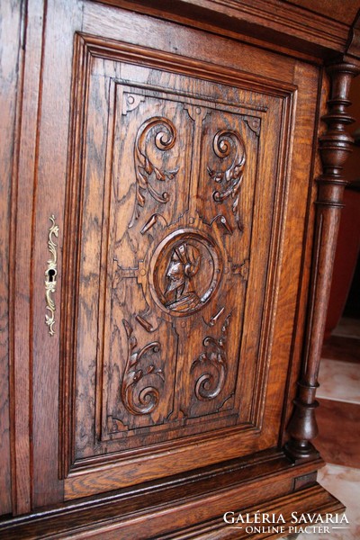 Old German richly carved oak chest of drawers