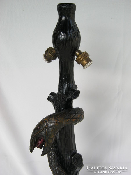 Old wooden lamp fixture coiling snake