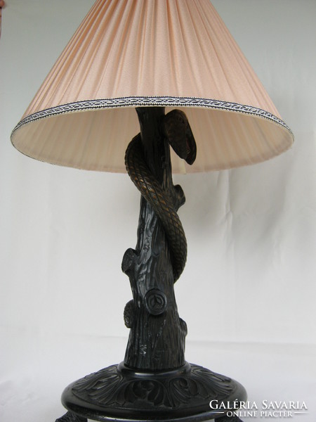 Old wooden lamp fixture coiling snake