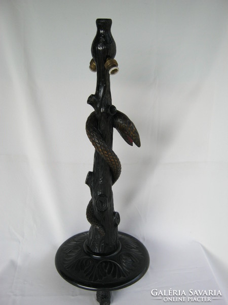 Old wooden lamp fixture coiling snake