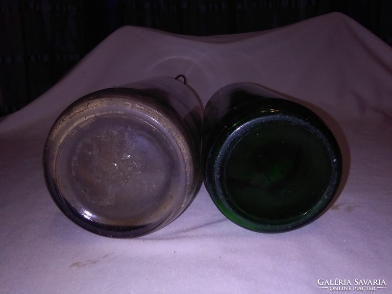 Two pieces of old buckled glass - green, white - together