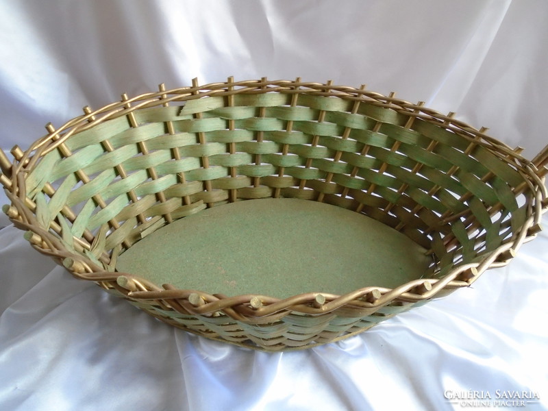 Large gold-green flower arrangement or decorative wicker basket.