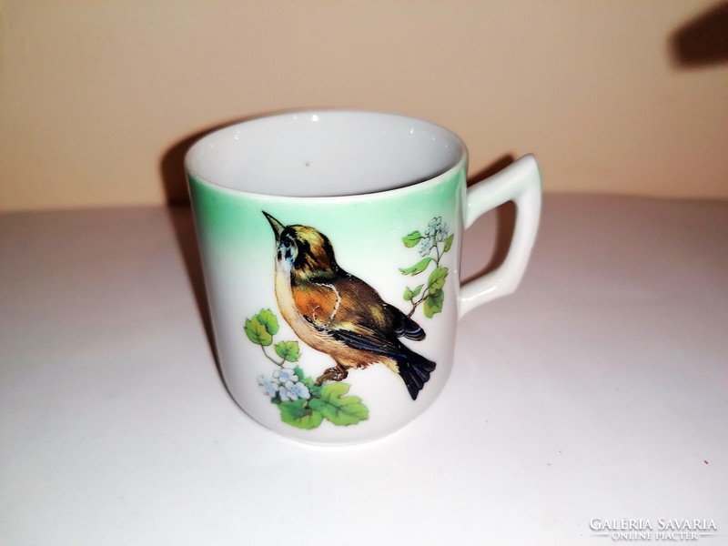 Antique birdie collecting coffee cup