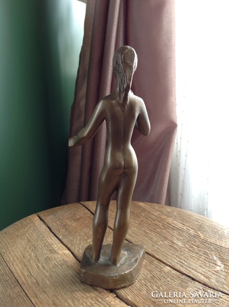 Old danger present copper statue of female nude