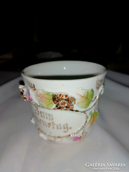 Antique commemorative cup from the early 1900s with a plastic flower ornament