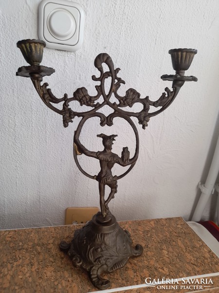 Old two-pronged copper candlestick with court jester