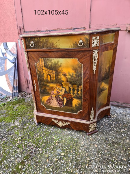 A drum chest painted with a gentleman's scene