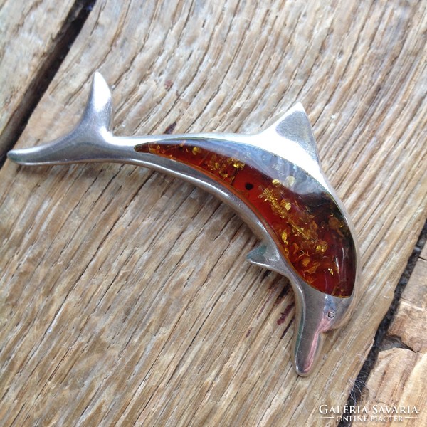 Silver dolphin brooch decorated with amber stone
