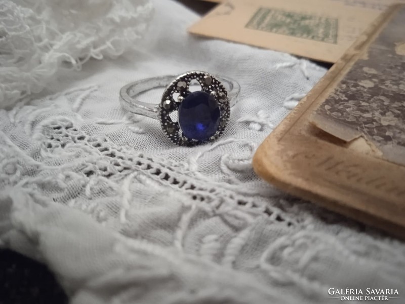 Old jewelry ring decorated with sapphire-like stone and marcasite.