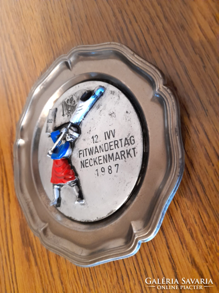 Old souvenir from Austria on a tin wall plate