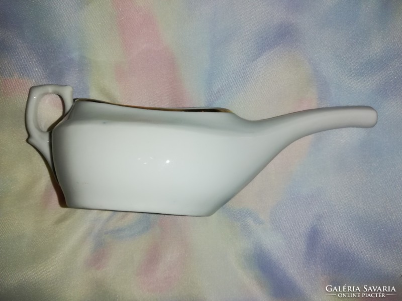 Aged, graceful porcelain sauce pourer