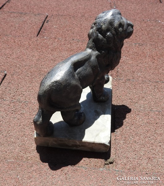 Antique cast solid iron lion statue on marble pedestal