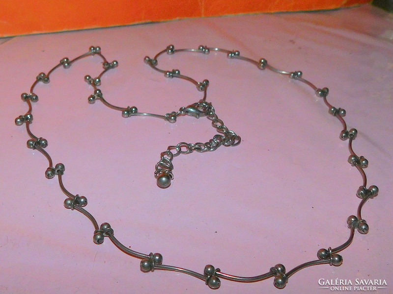 Stainless steel necklace with many spherical and curved shapes
