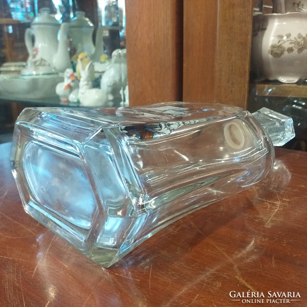 Liquor thick glass bottle with sailing decoration.