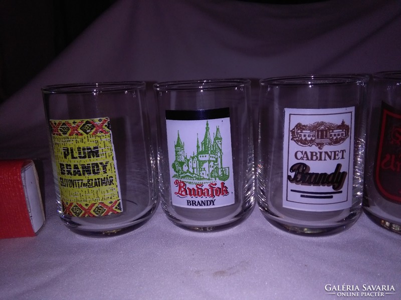 Six glass glasses with different short drink labels