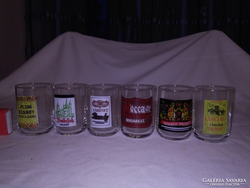 Six glass glasses with different short drink labels