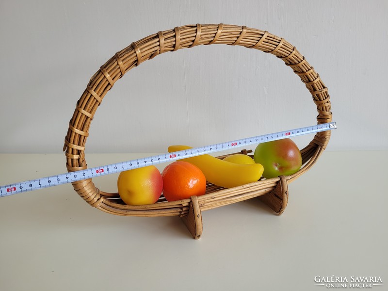 Old retro wicker basket on table offering fruit basket with plastic fruits