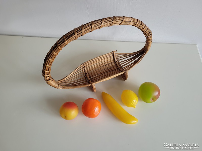 Old retro wicker basket on table offering fruit basket with plastic fruits