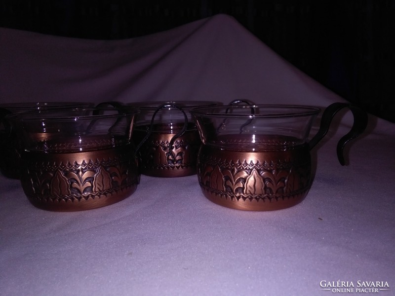 Artistically worked brass cups and Jena glasses - tea