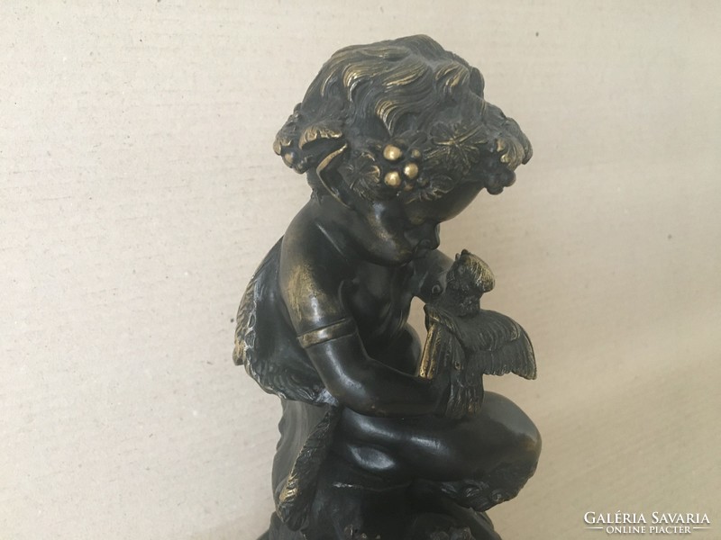 Old bronze faun on marble base