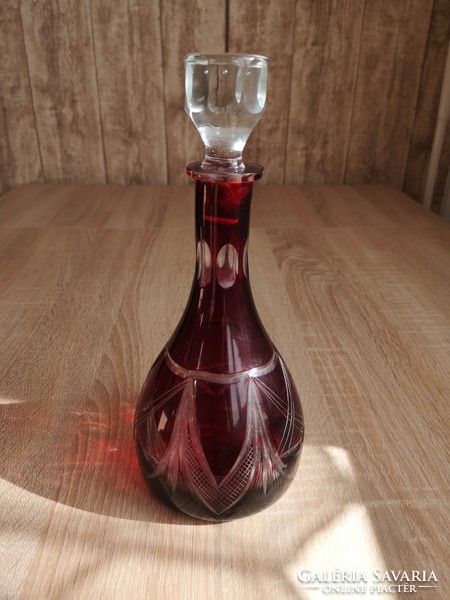 Lip crystal burgundy liqueur bottle with polished decoration.