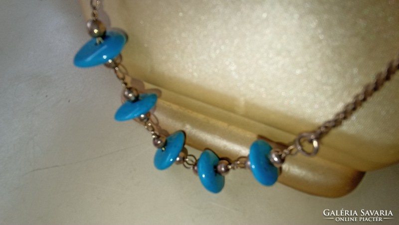 Silver necklace decorated with real turquoise discs in blue.