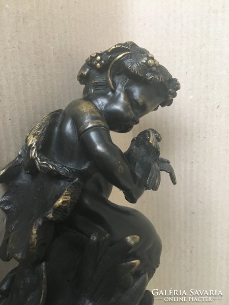 Old bronze faun on marble base