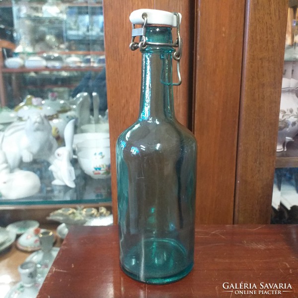 Porcelain buckle blue glass bottle. Arnas indicated. 23 Cm.
