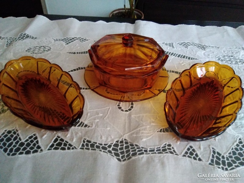 Amber octagonal glass butter holder with two wavy edges, together.