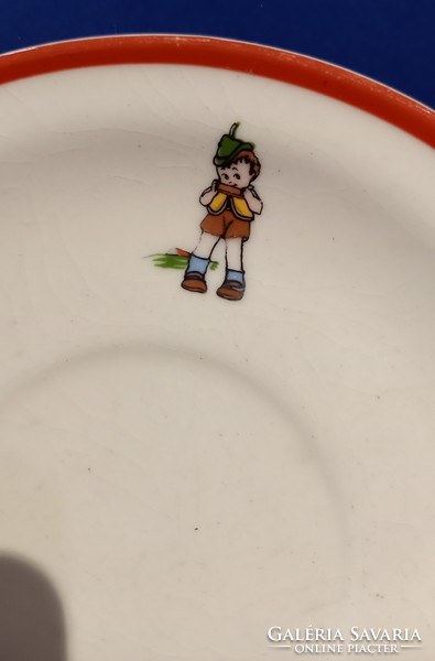 A saucer depicting a little girl and a little boy