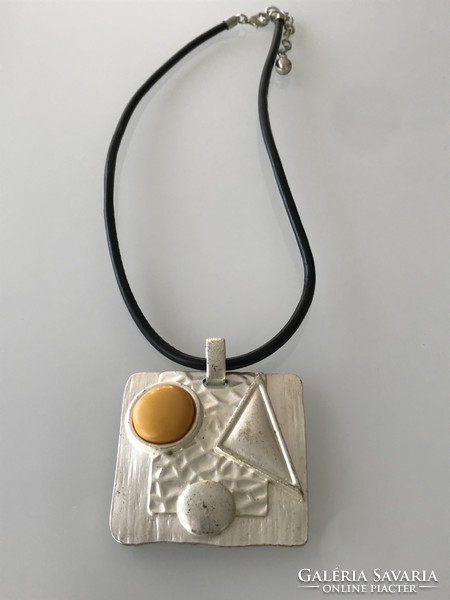 Applied art necklace with a huge pendant and a ceramic insert