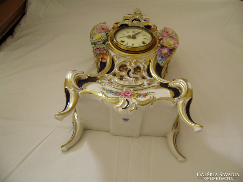 Neo-baroque porcelain clock from the 1950s-60s is stored in a new condition in a display case for sale