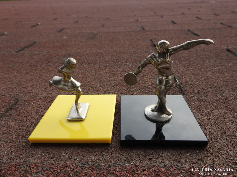 Old miniature statues of athletes on glass soles of disc jockeys / skaters
