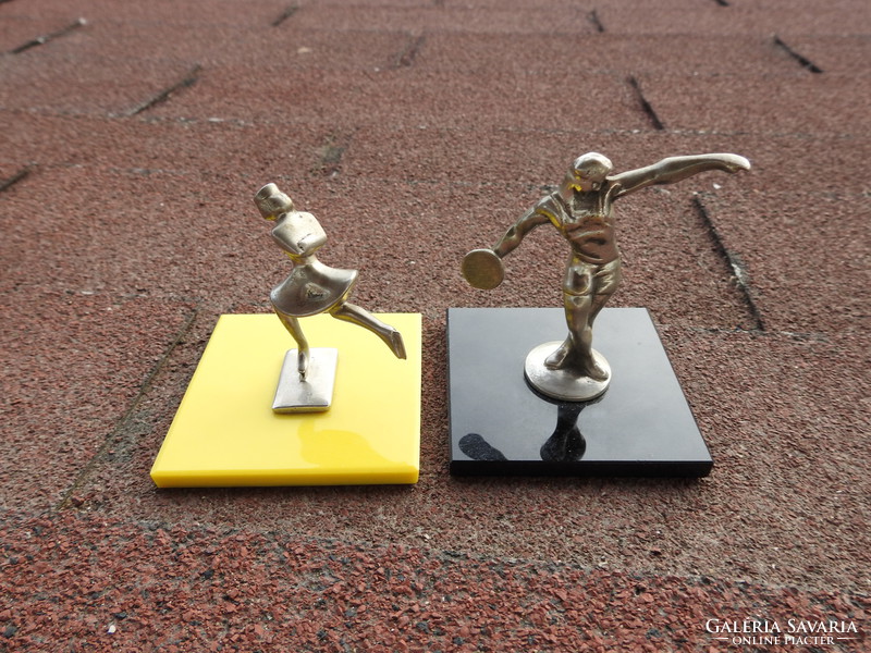 Old miniature statues of athletes on glass soles of disc jockeys / skaters