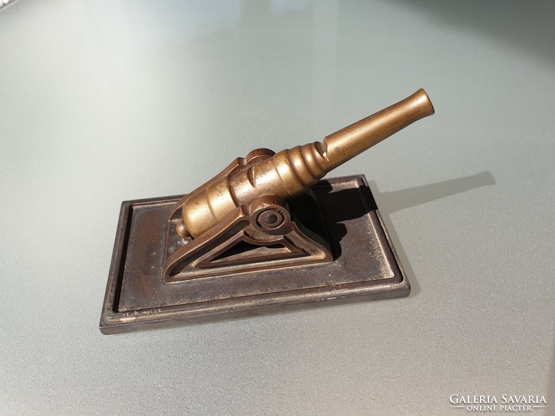 Old vintage table decoration with bronze cannon on copper table ornament