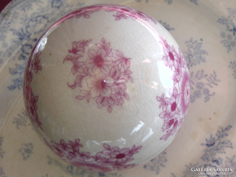 Porcelain sphere with pink floral on a cream-white background