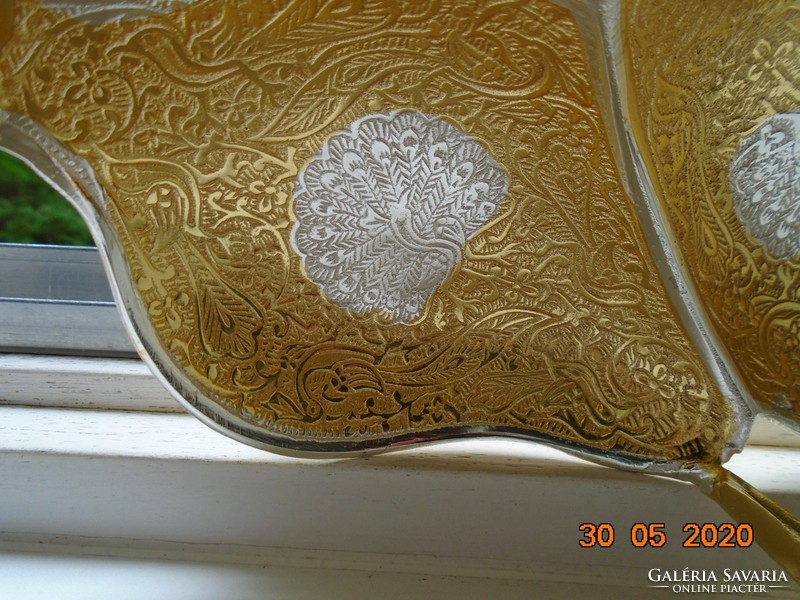 Handmade table centerpiece with a pair of gilded plastic swans, detailed relief patterns