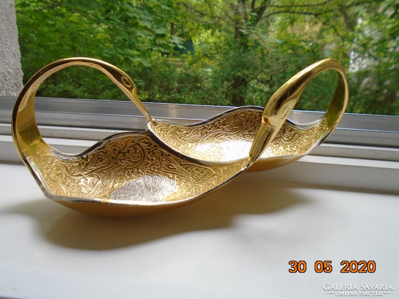 Handmade table centerpiece with a pair of gilded plastic swans, detailed relief patterns