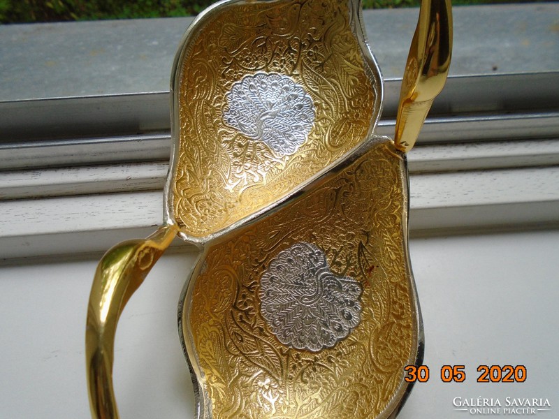 Handmade table centerpiece with a pair of gilded plastic swans, detailed relief patterns