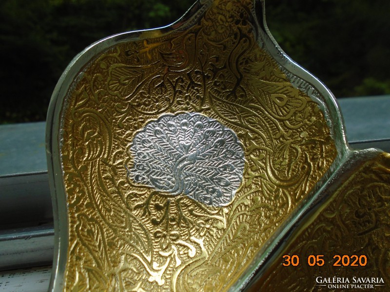 Handmade table centerpiece with a pair of gilded plastic swans, detailed relief patterns