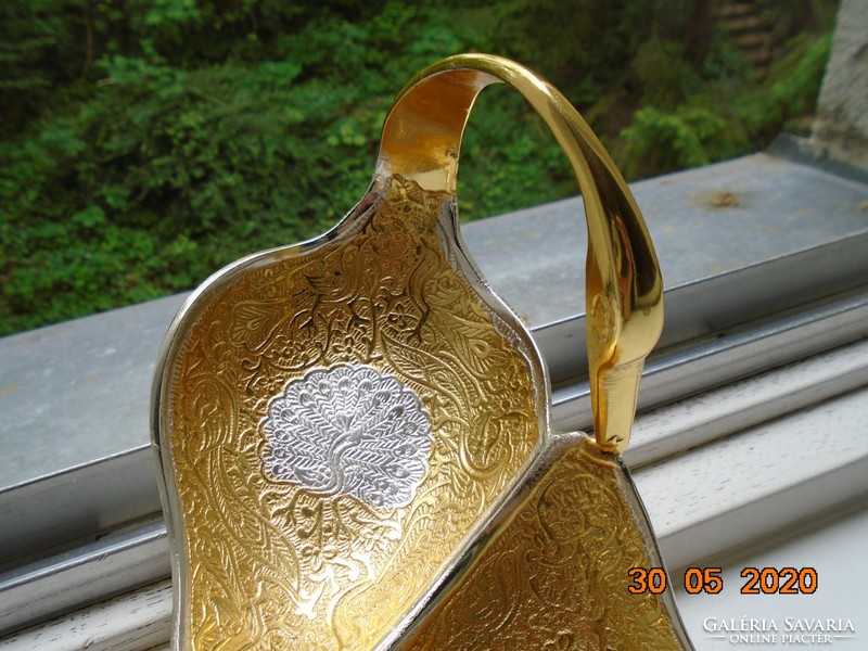 Handmade table centerpiece with a pair of gilded plastic swans, detailed relief patterns